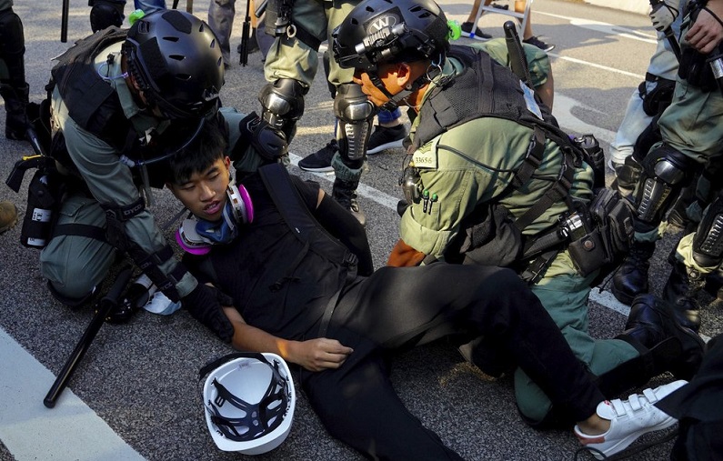 Hong Kong protesters burn flag, police fire pepper spray