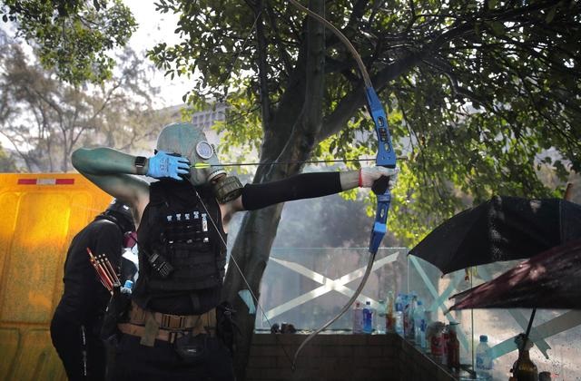 Hong Kong protesters fight off police with fire and arrows